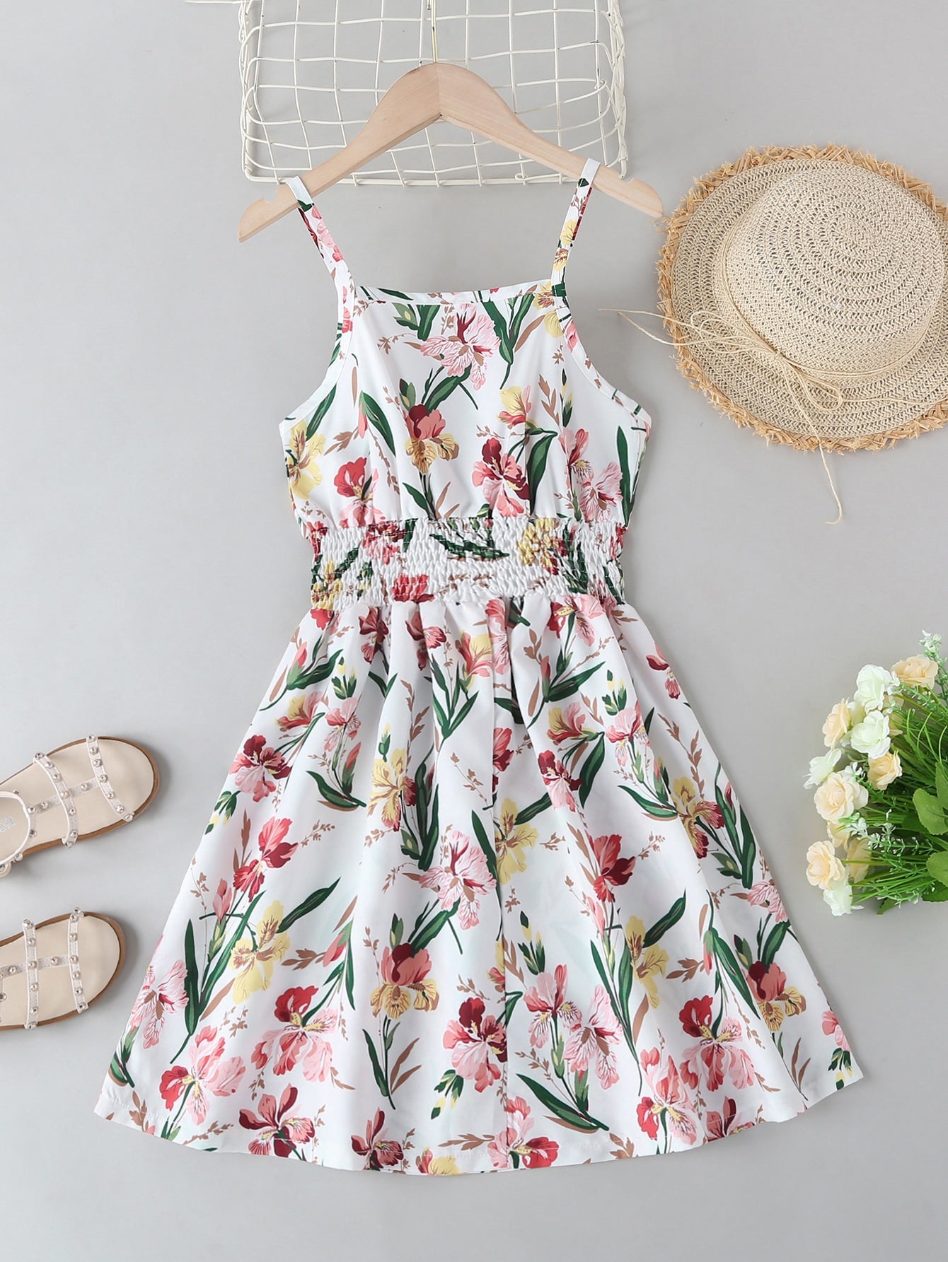 Tween girls floral mini dress with spaghetti straps, ruched shirred bodice, frill details, ruffle hem, high waist, and flared short silhouette for summer casual wear.