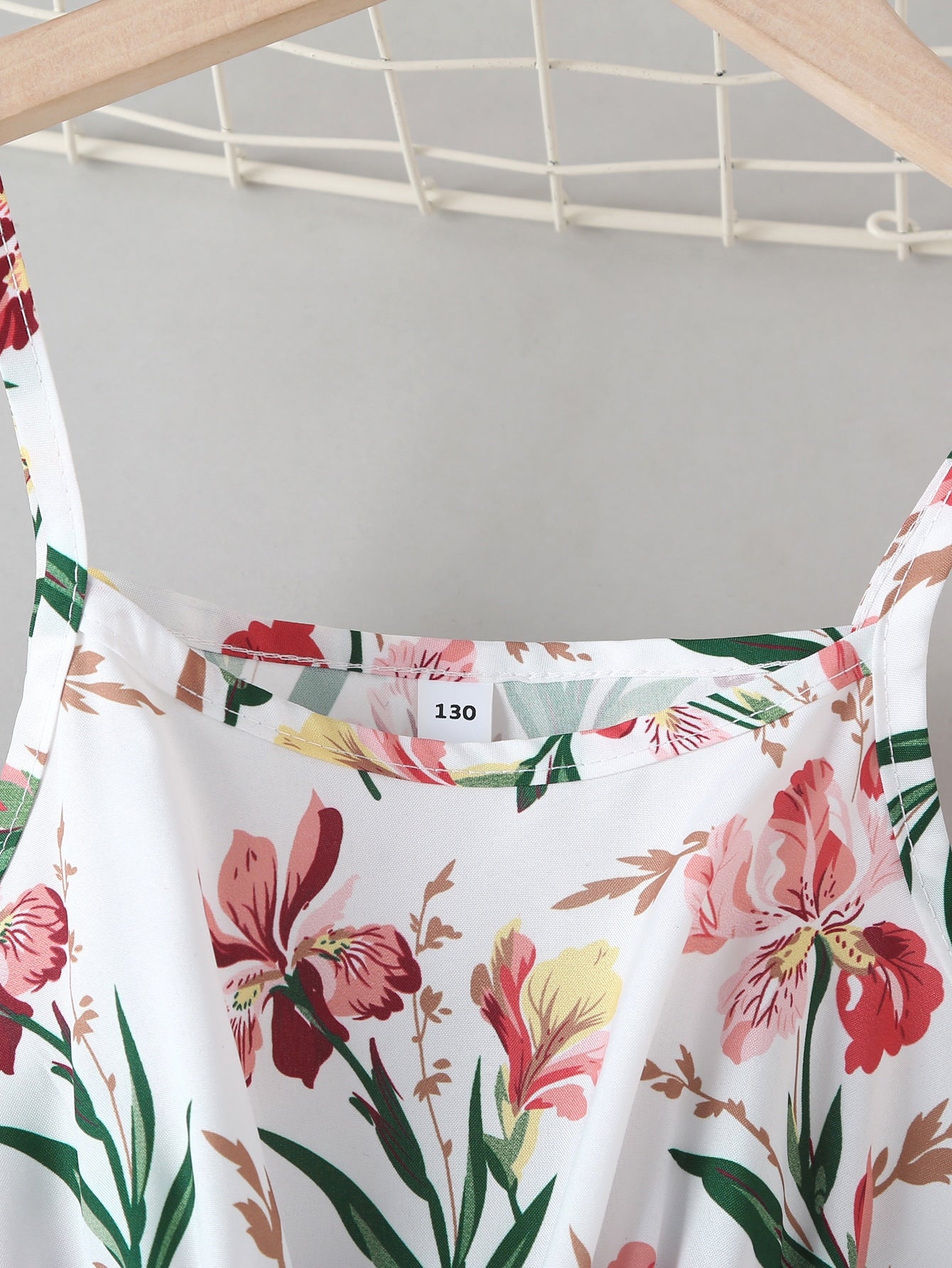 Tween girls floral mini dress with spaghetti straps, ruched shirred bodice, frill details, ruffle hem, high waist, and flared short silhouette for summer casual wear.