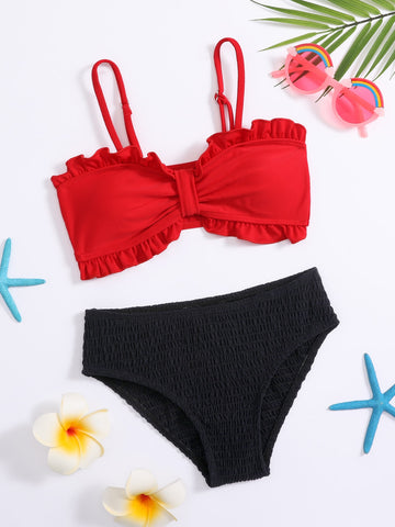 Red tween girls bikini set with a colorblock design, smocked detailing, and frill trim. Includes a wireless spaghetti strap bikini top and lined mid-waist bikini bottoms with slight stretch.