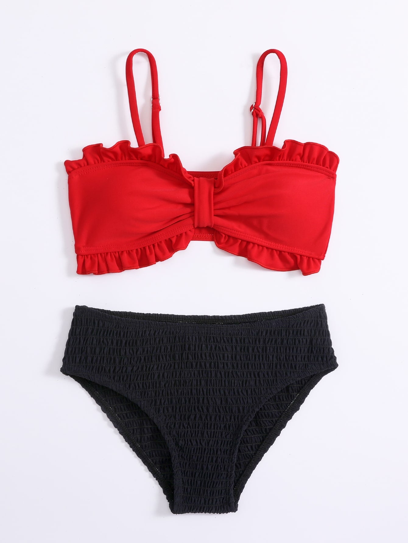Red tween girls bikini set with a colorblock design, smocked detailing, and frill trim. Includes a wireless spaghetti strap bikini top and lined mid-waist bikini bottoms with slight stretch.