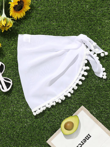 White tween girls cover up skirt with knot side, pom pom trim, asymmetrical hem, long semi-sheer design, and plain summer beachwear style.