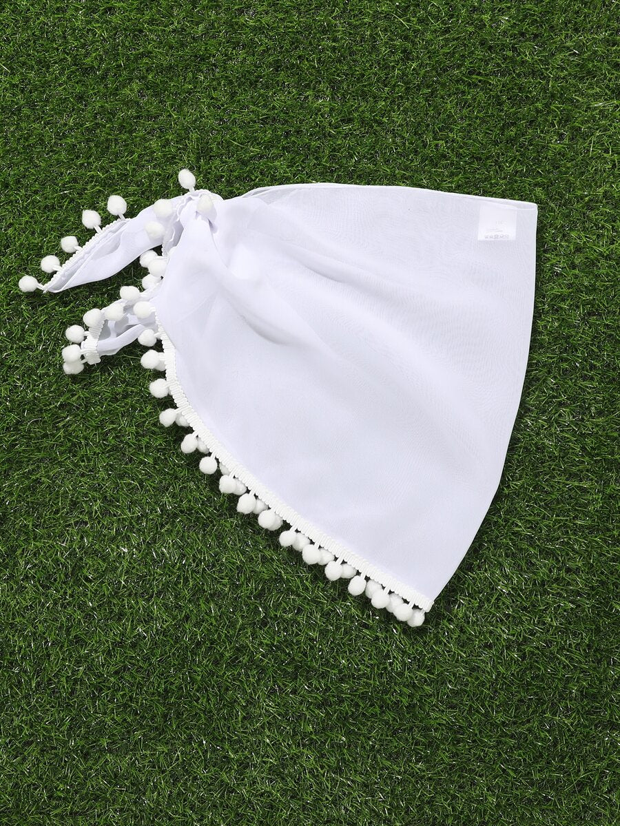 White tween girls cover up skirt with knot side, pom pom trim, asymmetrical hem, long semi-sheer design, and plain summer beachwear style.