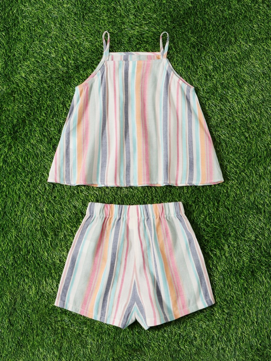 Tween girl wearing a multicolor rainbow striped camisole top with spaghetti straps and matching boho shorts.