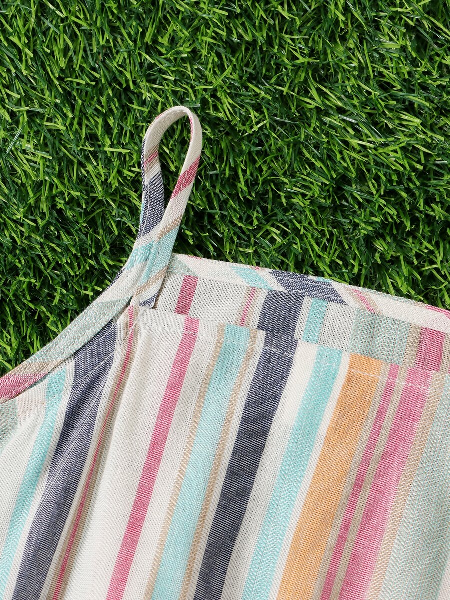 Tween girl wearing a multicolor rainbow striped camisole top with spaghetti straps and matching boho shorts.