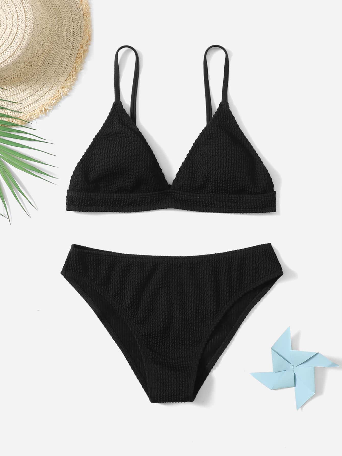 Tween girls two-piece bikini swimwear set with a solid color textured design, spaghetti strap top, wireless bra, and mid-waist lined bikini bottoms.