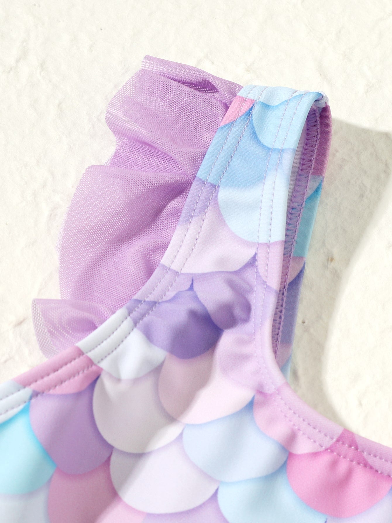 Tween girl one-piece swimsuit with multicolor fish scale graphic print, ruffle details, contrast mesh, round neck, and skirt bottom for beach or pool wear