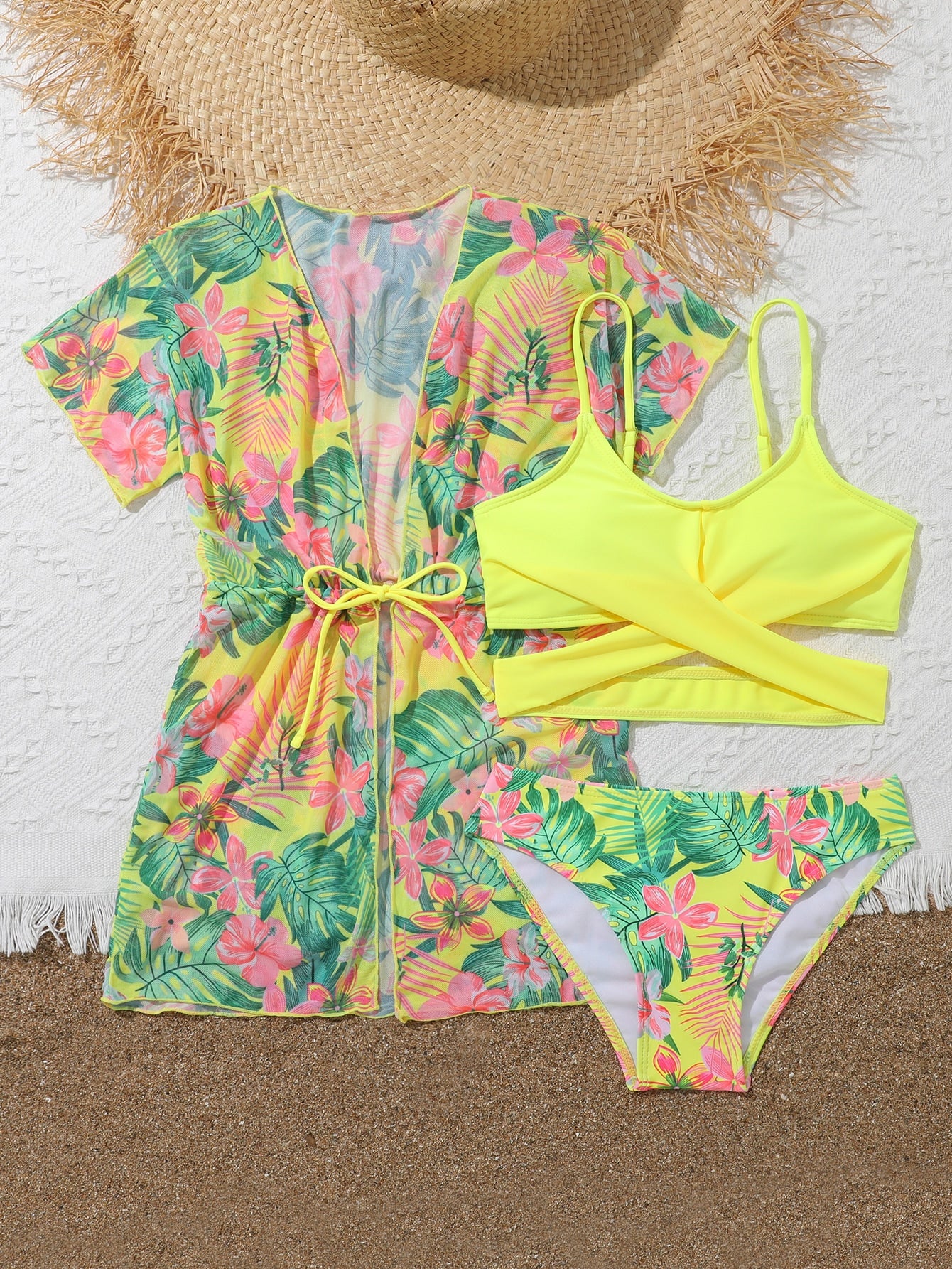 Three-piece tween girls swimwear set with a floral print, featuring a criss-cross bikini top, regular bikini bottoms, and a kimono cover-up in assorted prints.