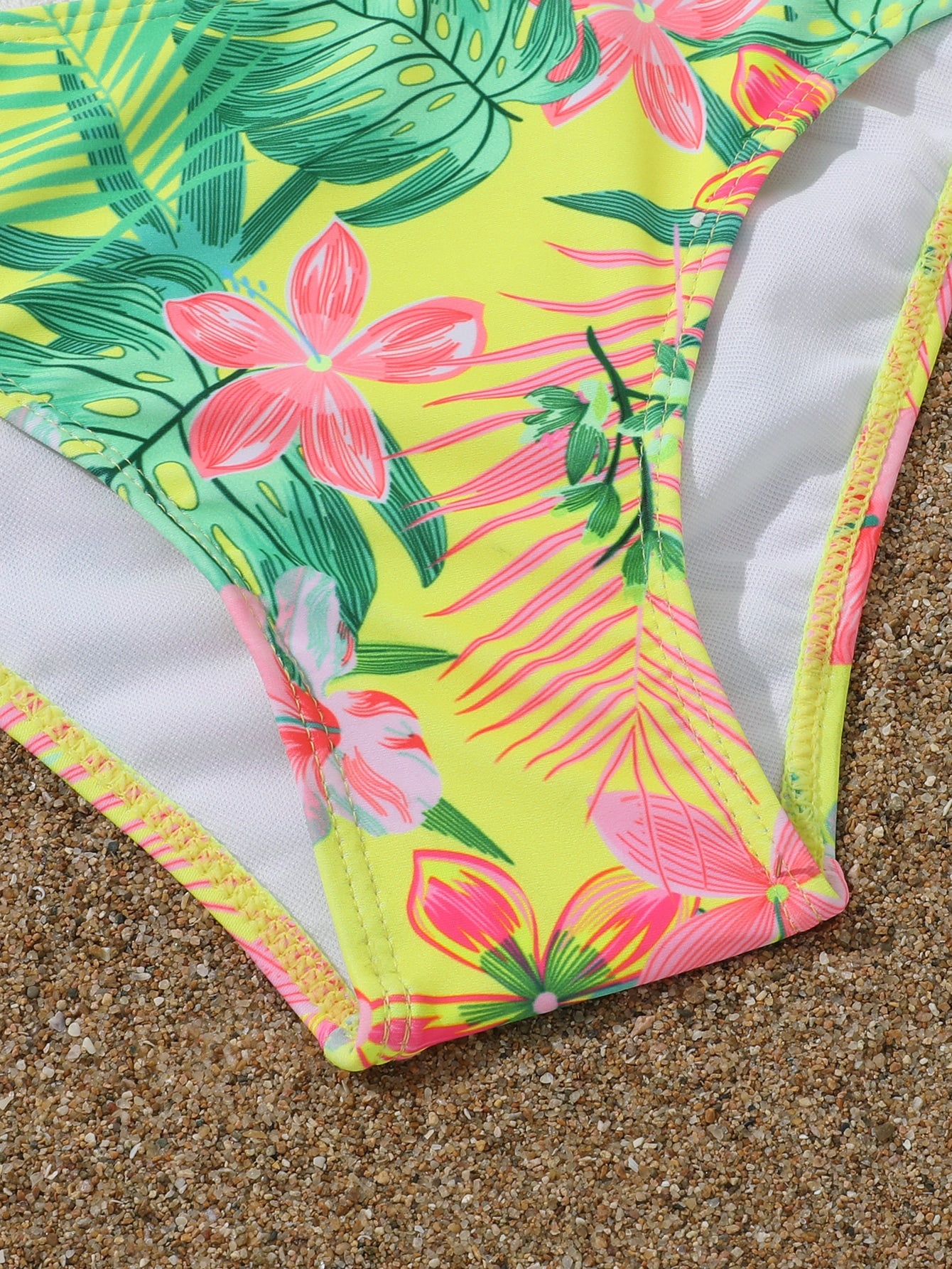 Three-piece tween girls swimwear set with a floral print, featuring a criss-cross bikini top, regular bikini bottoms, and a kimono cover-up in assorted prints.