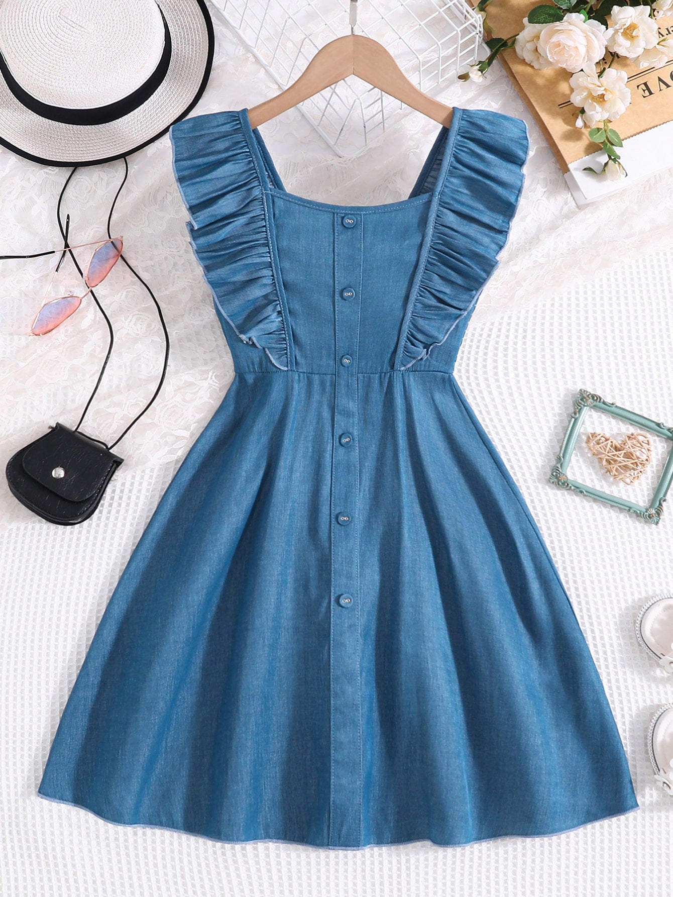 Vintaside tween girls sleeveless blue A-line dress featuring ruffle trim, square neckline, button front, and shirred back.