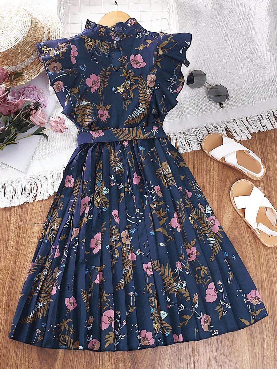 Tween girl wearing navy blue floral print ruffle trim belted pleated mini dress with stand collar and flounce cap sleeves