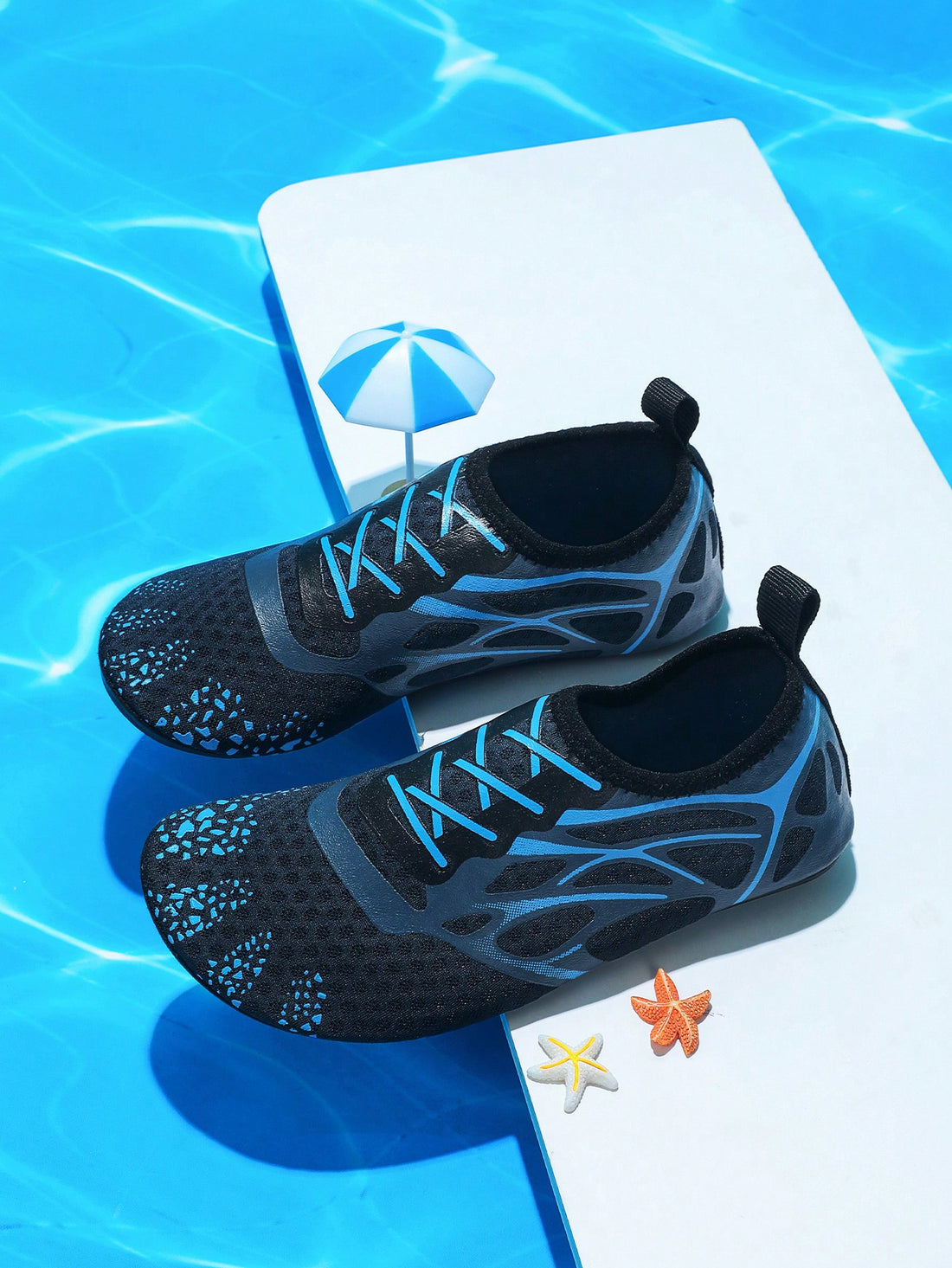 Multicolor boys' slip-on water shoes with geometric graphic pattern, breathable fabric upper, and non-slip TPR outsole.