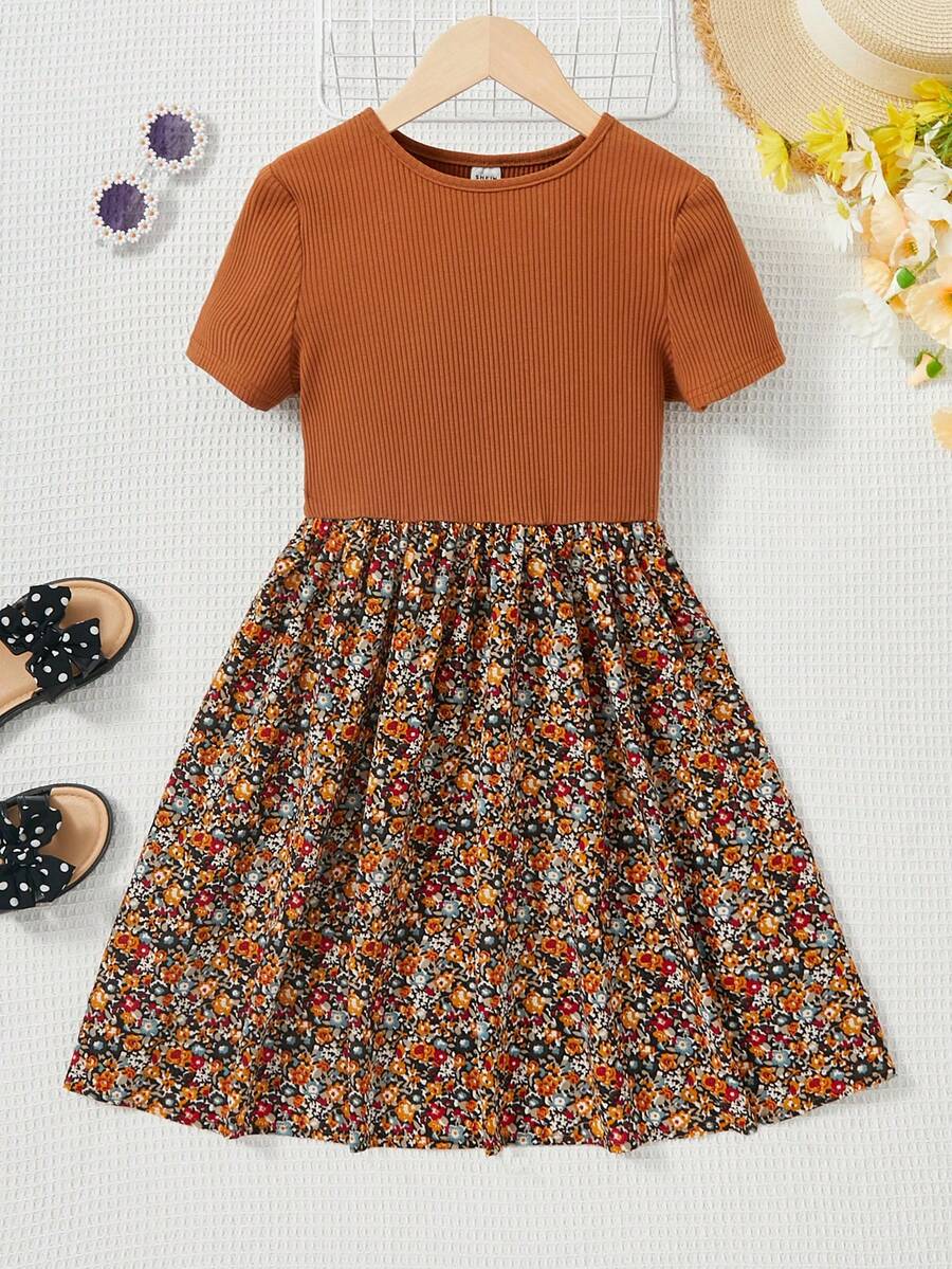 Tween girl wearing an apricot short sleeve A-line dress featuring a round neck, high waist with a belt, and flared hem.