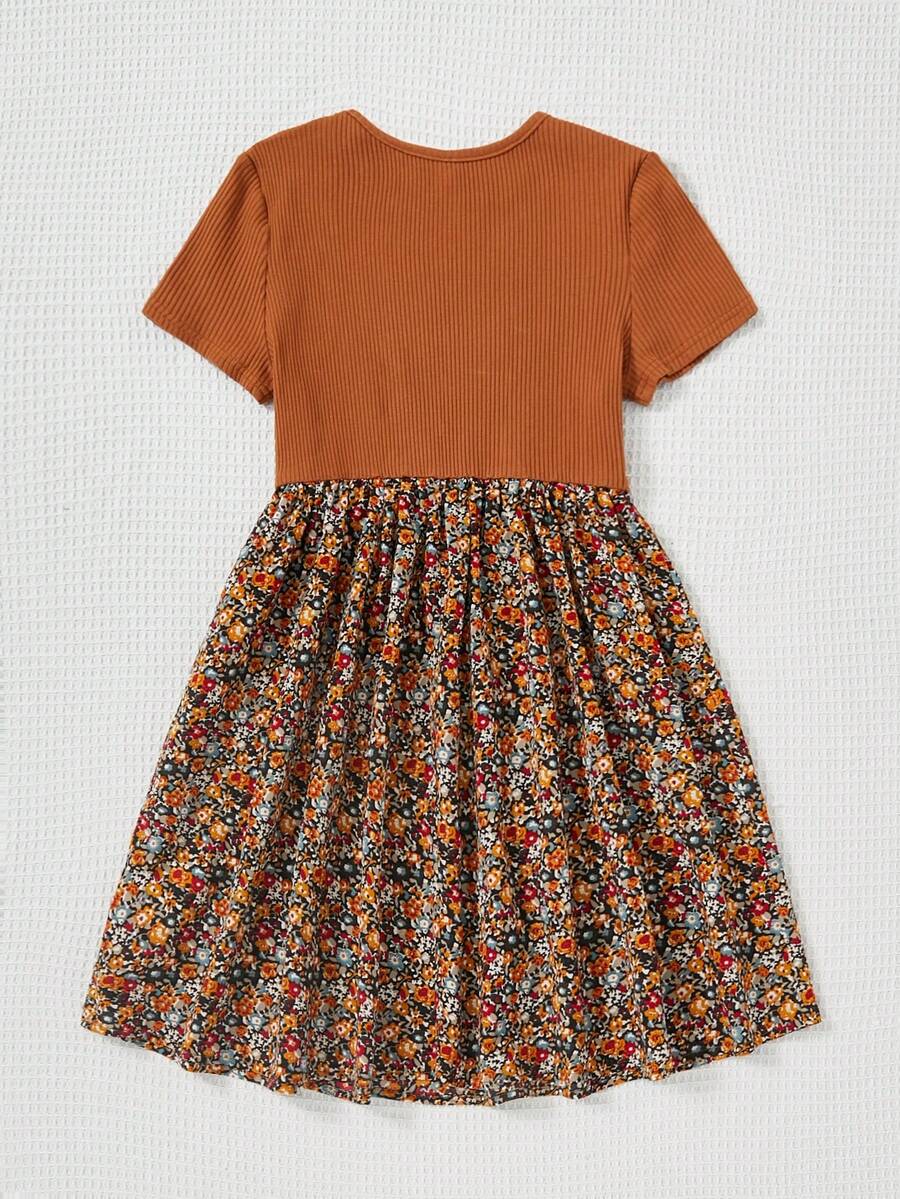 Tween girl wearing an apricot short sleeve A-line dress featuring a round neck, high waist with a belt, and flared hem.