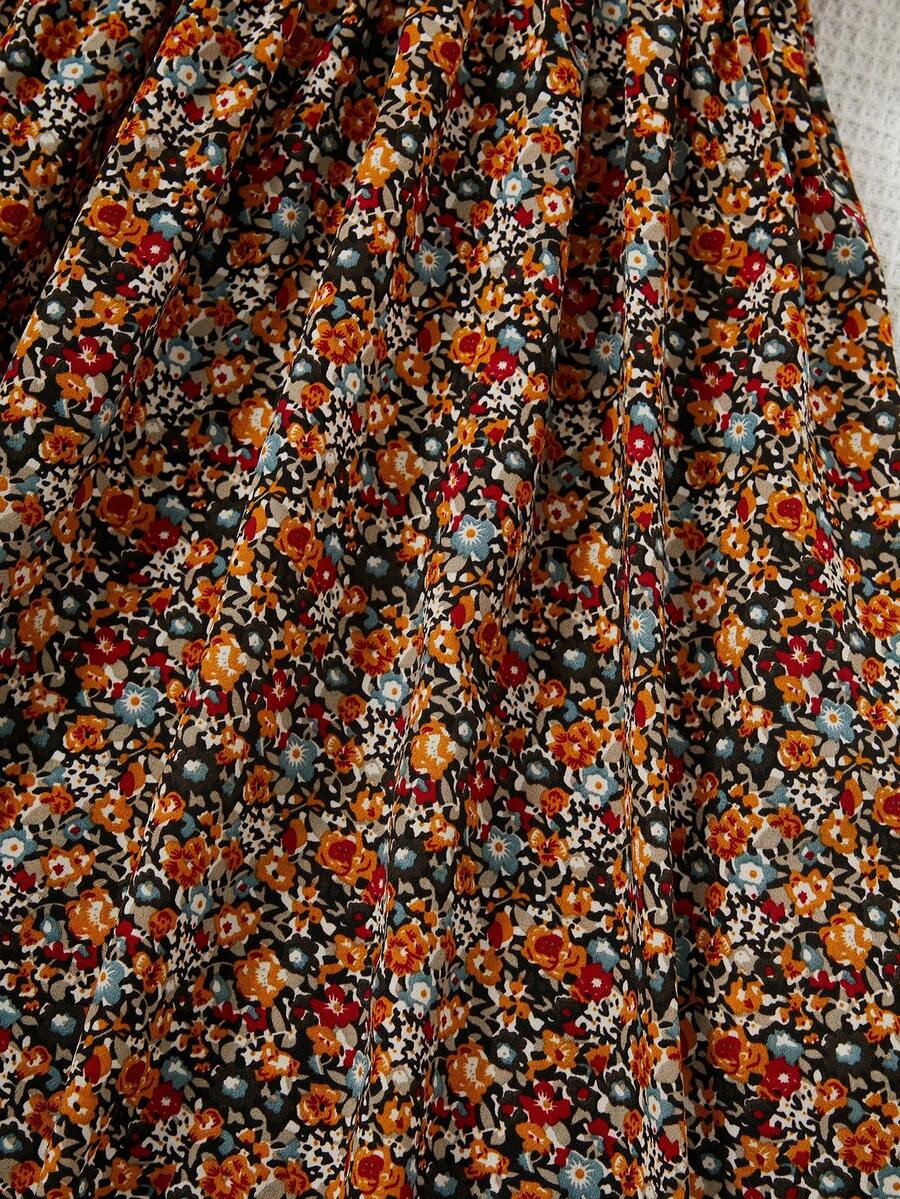 Tween girl wearing an apricot short sleeve A-line dress featuring a round neck, high waist with a belt, and flared hem.