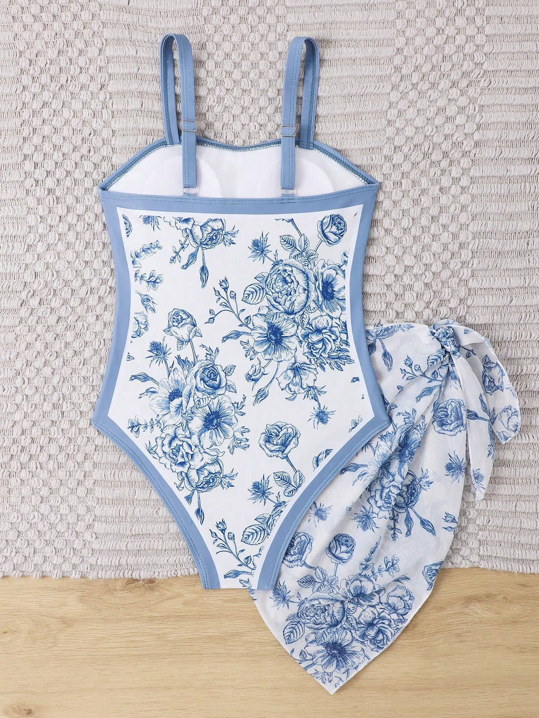 Tween girl multicolor floral one-piece swimsuit with asymmetrical spaghetti straps and knotted side swim skirt