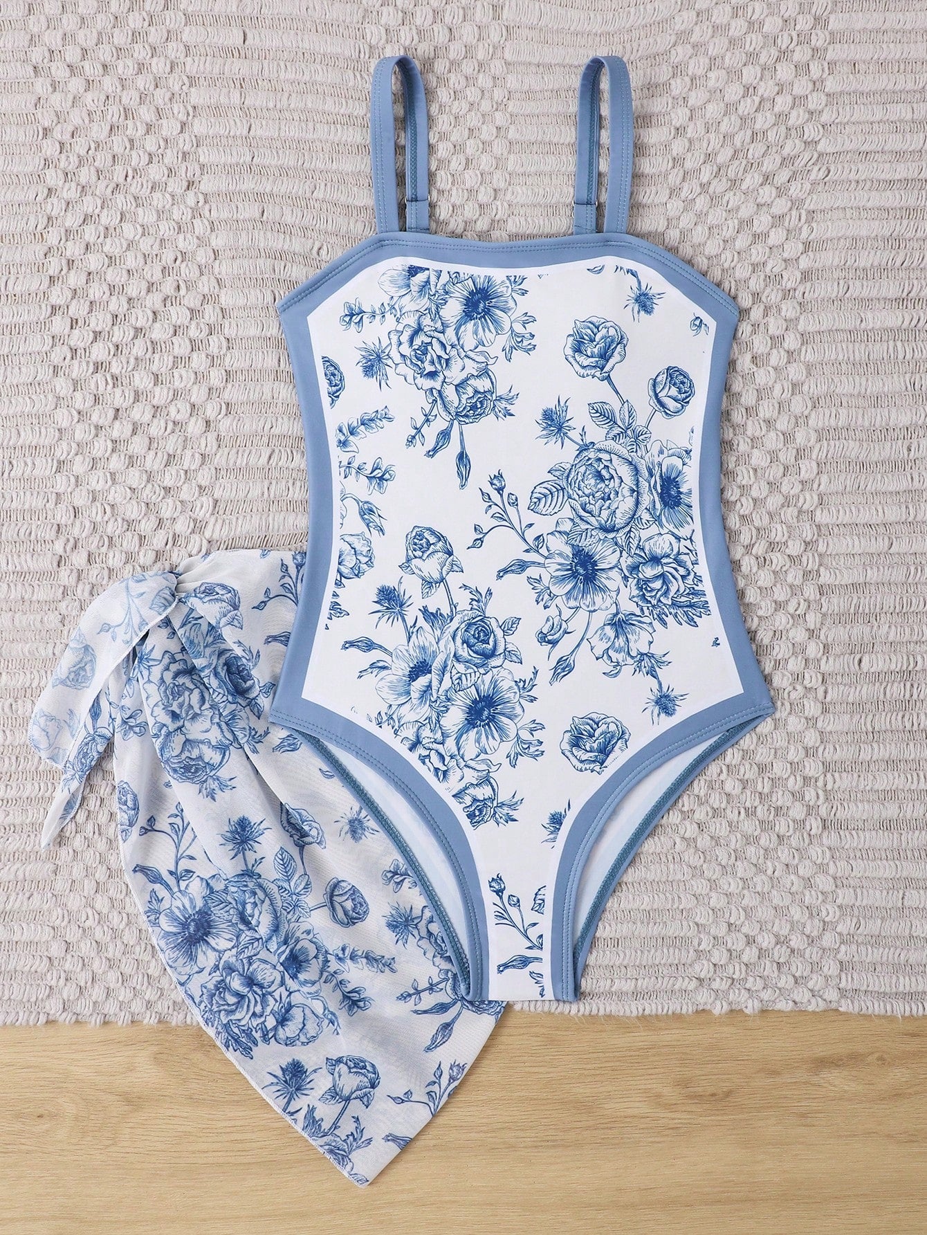 Tween girl multicolor floral one-piece swimsuit with asymmetrical spaghetti straps and knotted side swim skirt