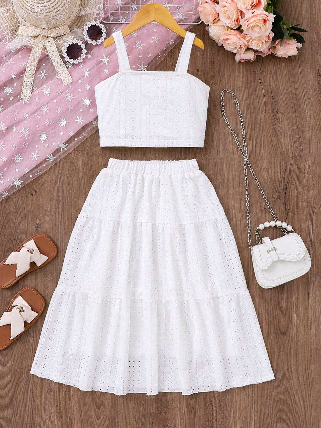 White 2-piece knit outfit for tween girls featuring a strap camisole top and tiered eyelet embroidery skirt with shirred details.
