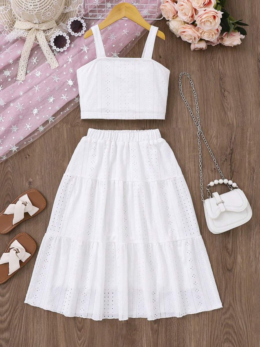 White 2-piece knit outfit for tween girls featuring a strap camisole top and tiered eyelet embroidery skirt with shirred details.