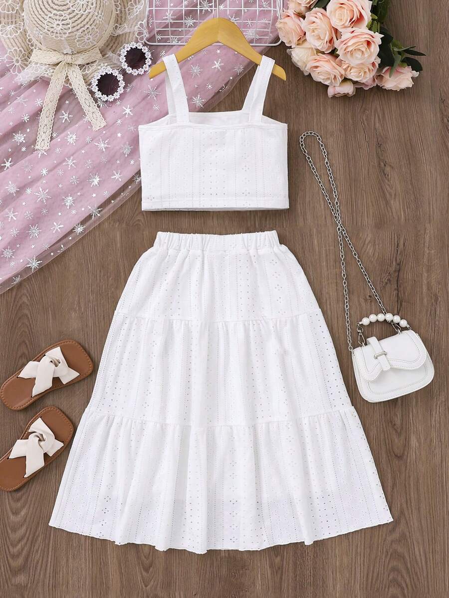 White 2-piece knit outfit for tween girls featuring a strap camisole top and tiered eyelet embroidery skirt with shirred details.
