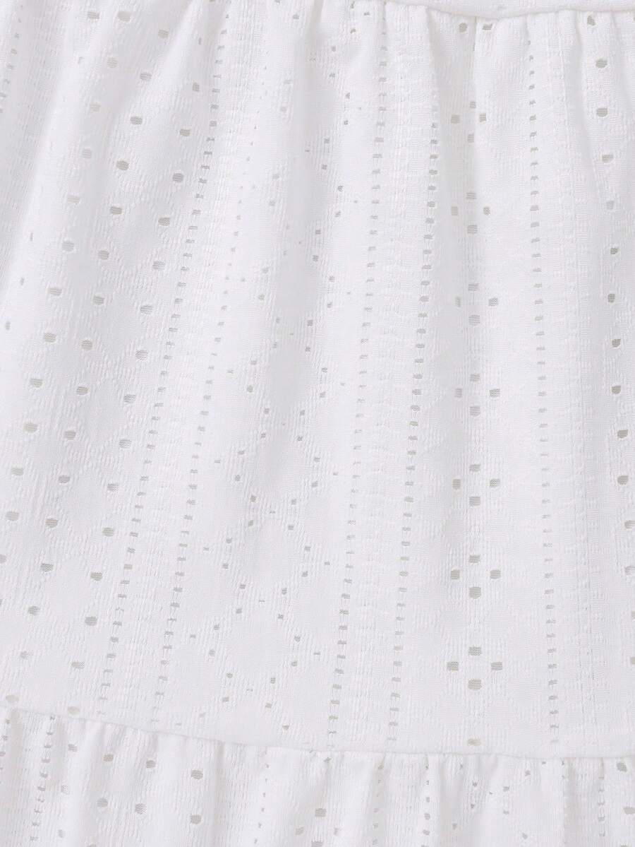 White 2-piece knit outfit for tween girls featuring a strap camisole top and tiered eyelet embroidery skirt with shirred details.