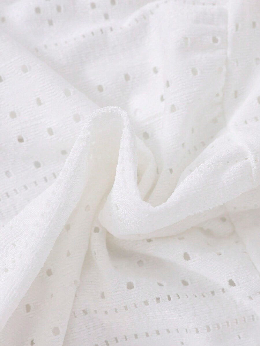 White 2-piece knit outfit for tween girls featuring a strap camisole top and tiered eyelet embroidery skirt with shirred details.