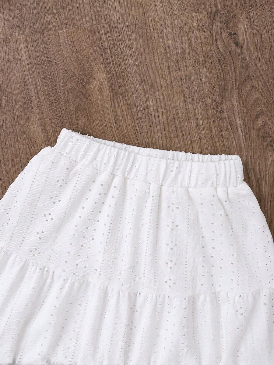White 2-piece knit outfit for tween girls featuring a strap camisole top and tiered eyelet embroidery skirt with shirred details.