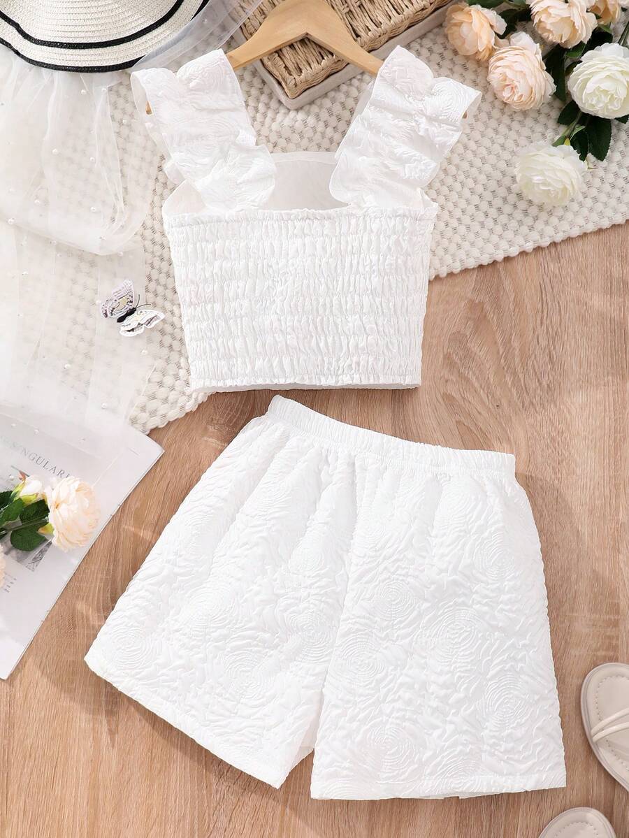 Apricot two-piece summer outfit for tween girls featuring a sleeveless pleated square-neck camisole top with button details and matching gathered shorts.