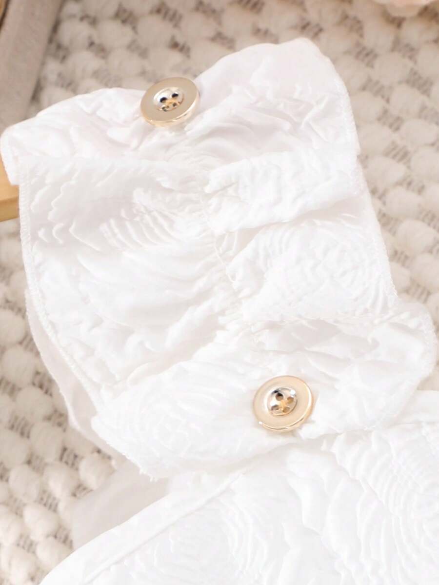 Apricot two-piece summer outfit for tween girls featuring a sleeveless pleated square-neck camisole top with button details and matching gathered shorts.