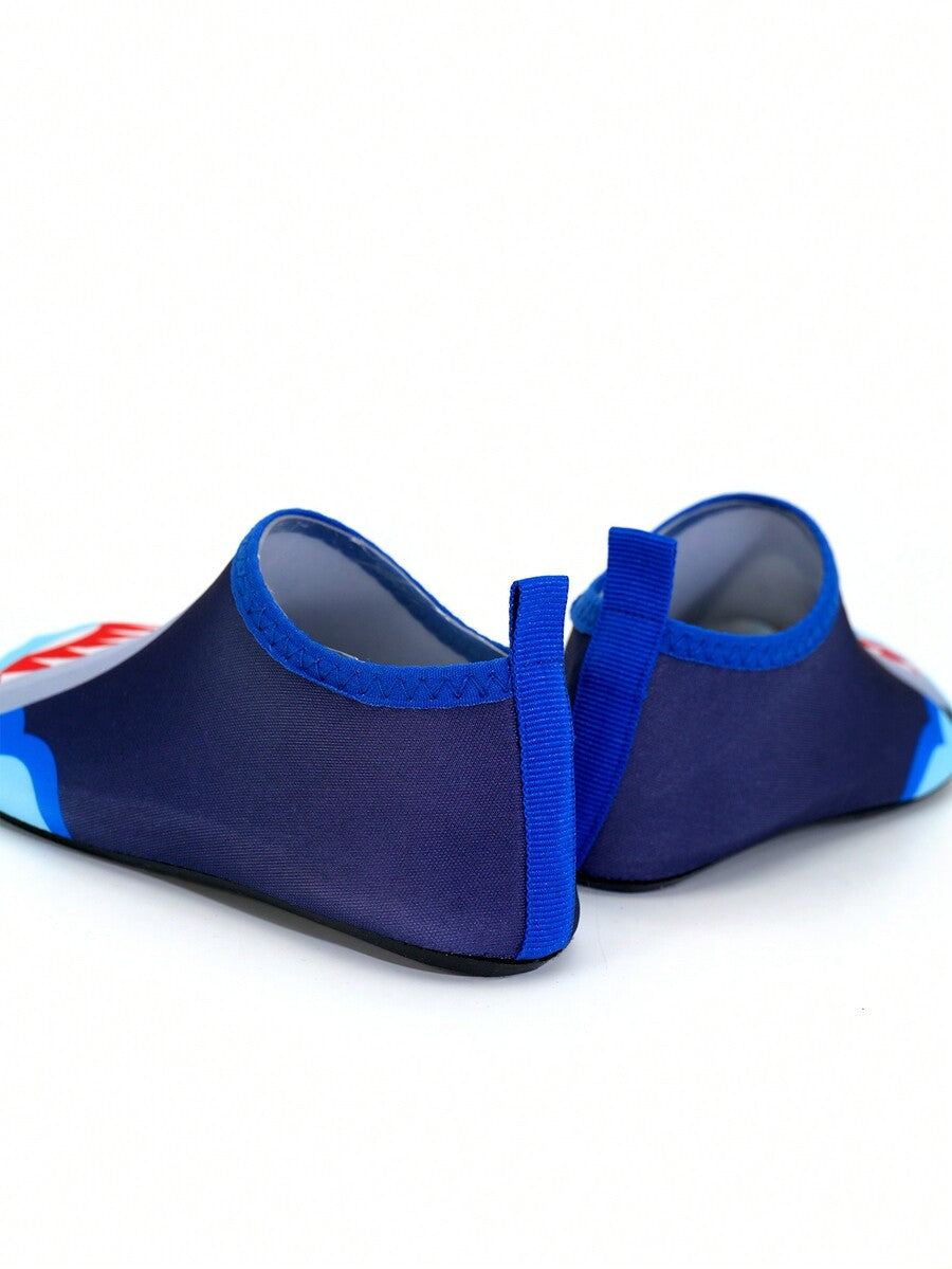 Multicolor cartoon pattern boys' aqua socks with breathable polyester upper, slip-on closure, and non-slip TPR outsole.