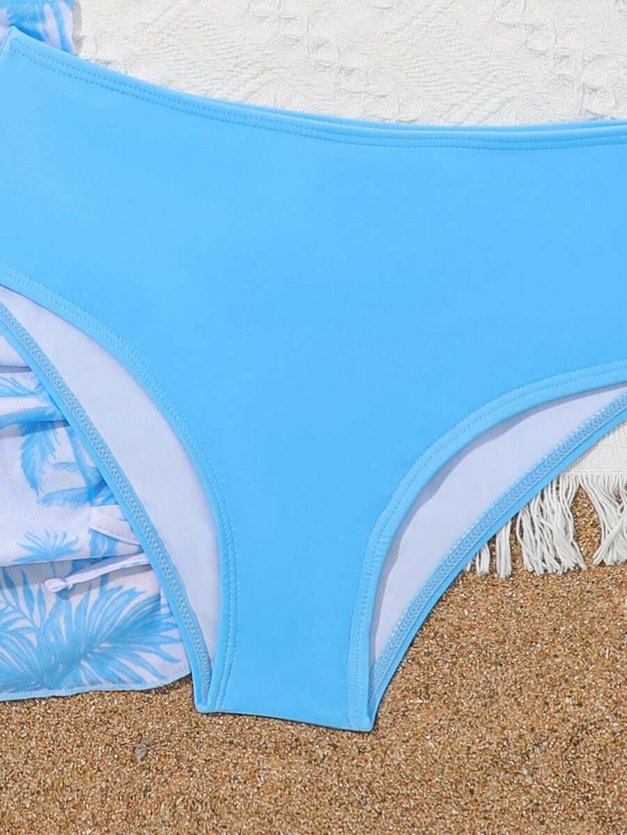 Tween girls 4-piece boho butterfly print bikini set in blue featuring spaghetti strap top, mid waist bottoms, and matching cover-up skirt.