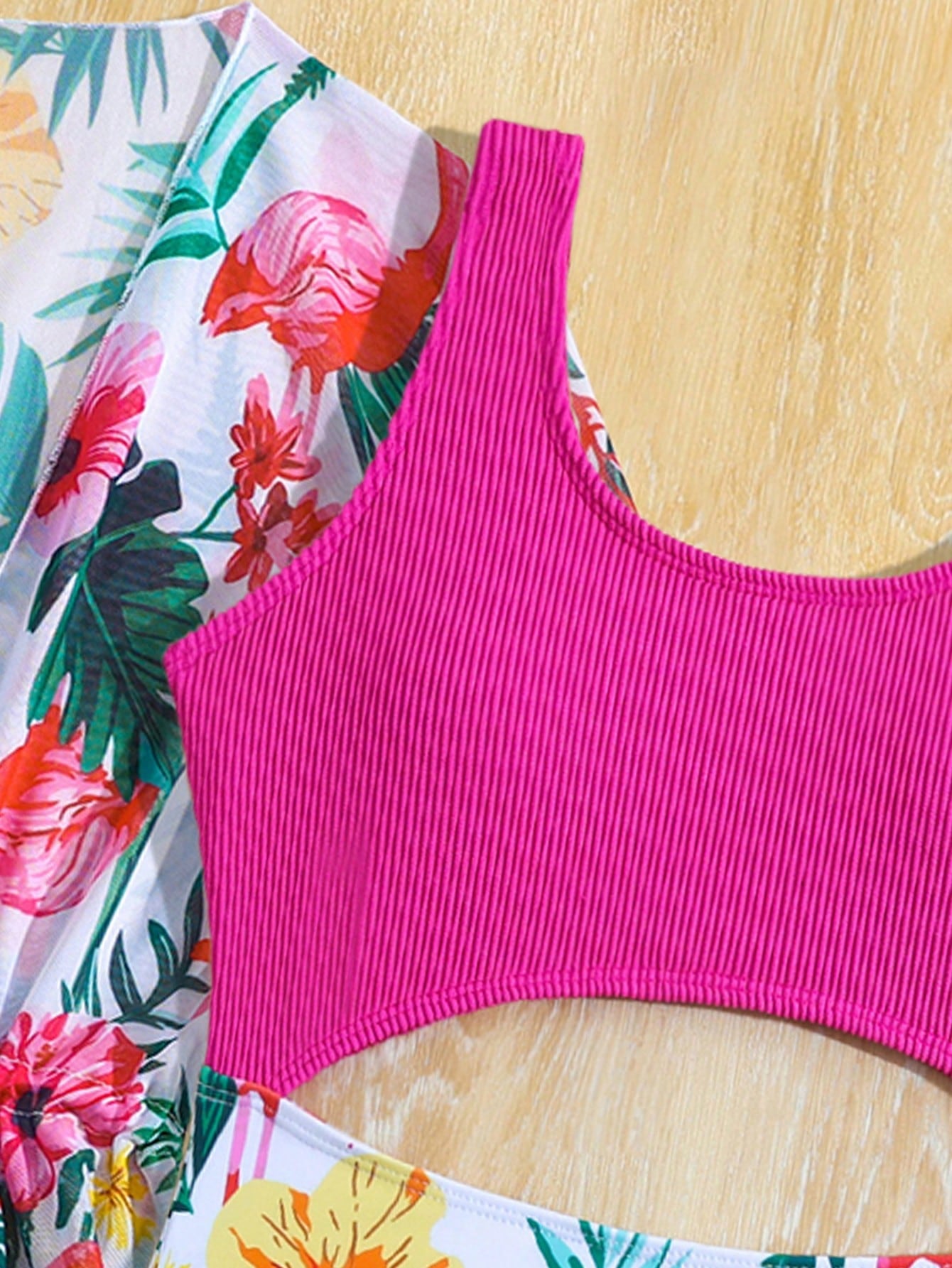 Tween girls multicolor 2-piece swimsuit set with scoop neck, cut-out details, patterned design, shorts-style bottoms, and sheer UV protection cover-up for beach and pool vacations.