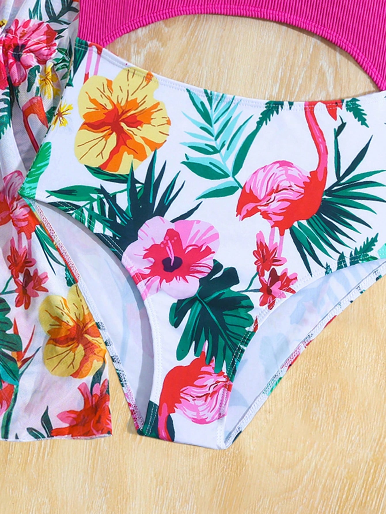 Tween girls multicolor 2-piece swimsuit set with scoop neck, cut-out details, patterned design, shorts-style bottoms, and sheer UV protection cover-up for beach and pool vacations.