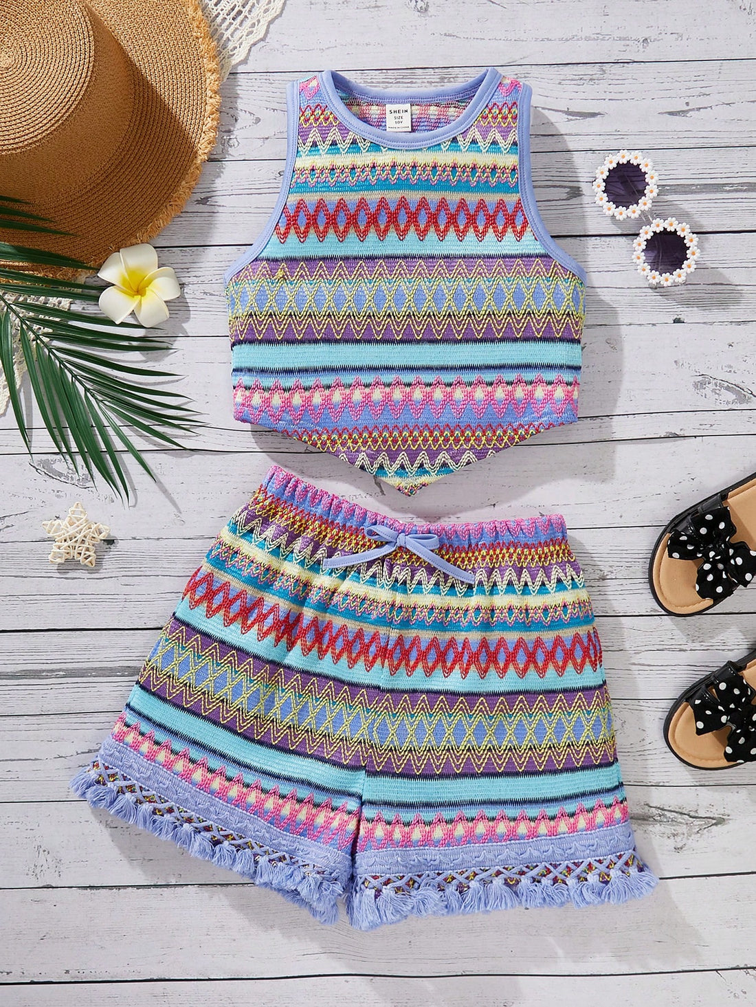 Tween girl wearing a blue boho sleeveless round neck tank top and matching printed shorts set with cable knit detailing.