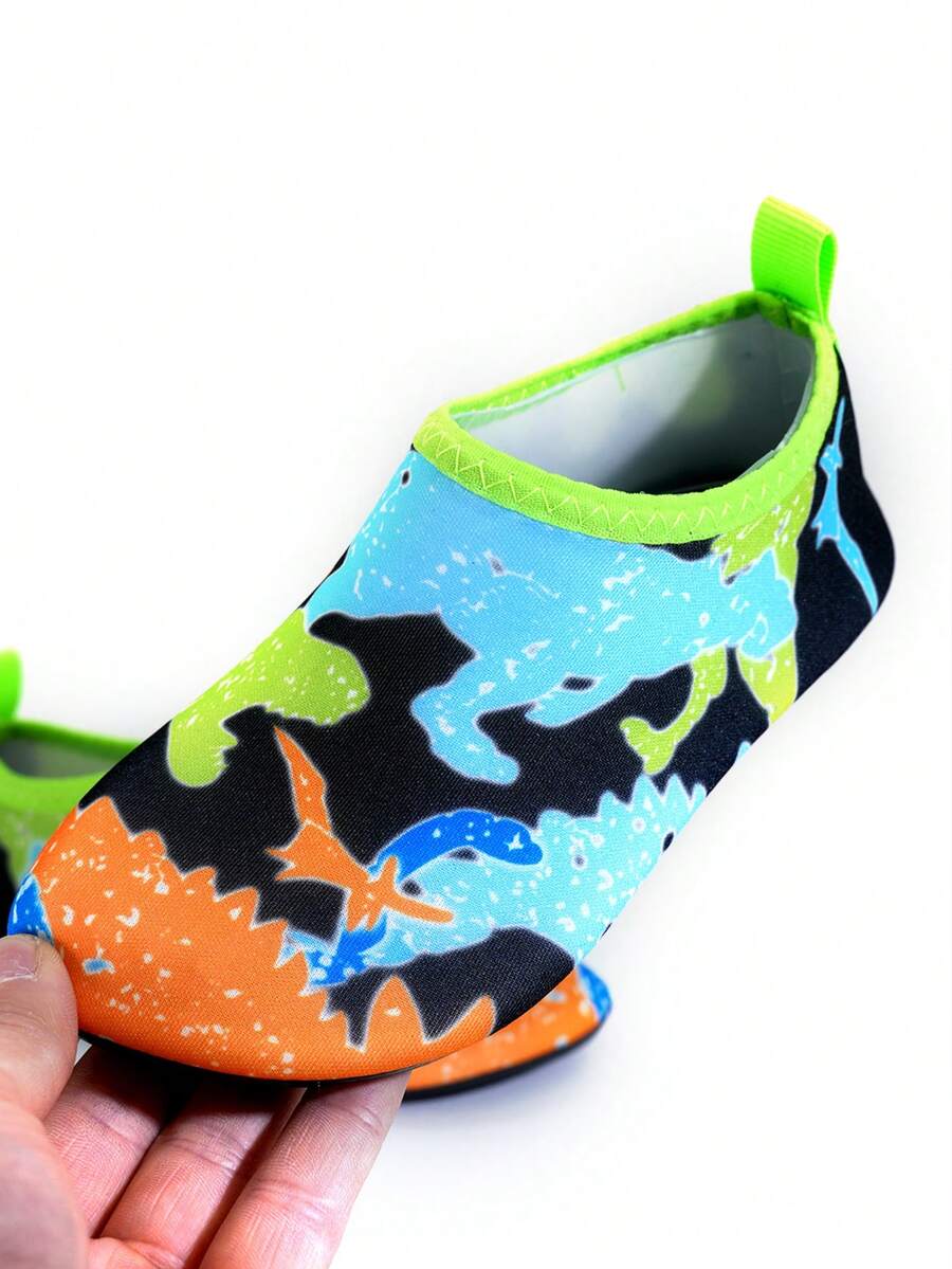 Multicolor cartoon pattern boys' aqua socks with breathable polyester upper, slip-on closure, and non-slip TPR outsole.