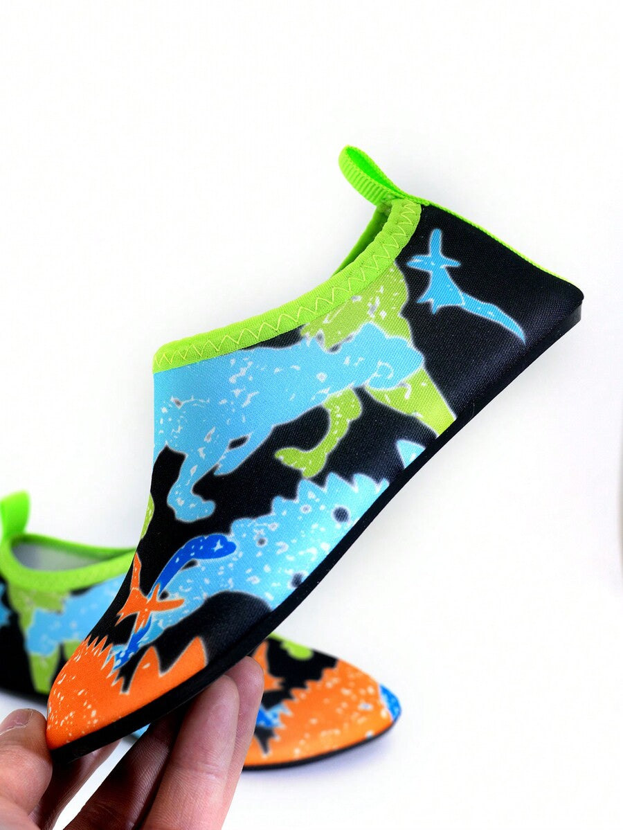 Multicolor cartoon pattern boys' aqua socks with breathable polyester upper, slip-on closure, and non-slip TPR outsole.