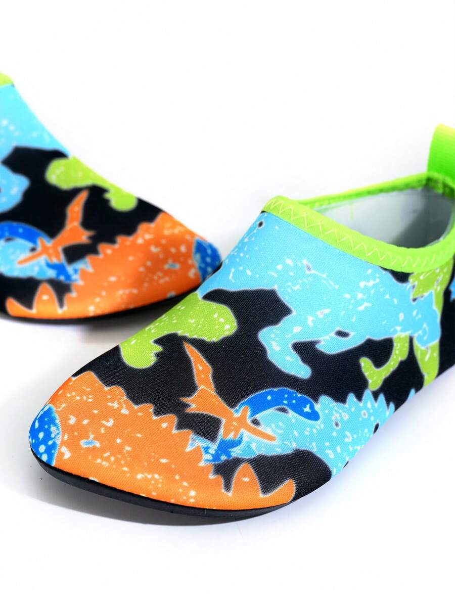 Multicolor cartoon pattern boys' aqua socks with breathable polyester upper, slip-on closure, and non-slip TPR outsole.