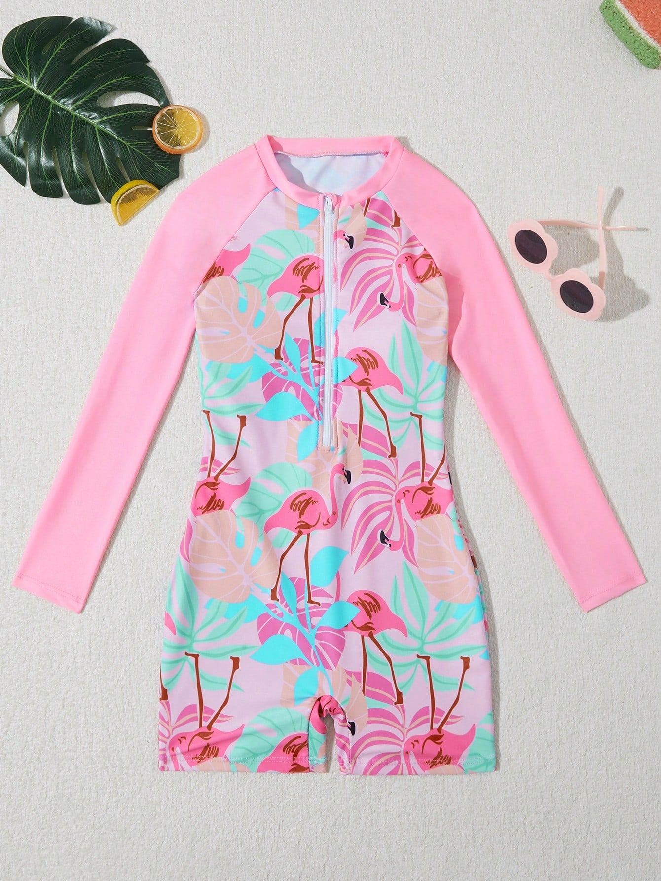 Tween girls one-piece swimsuit featuring a high neck, long sleeves, and shorts bottom, with a back zipper and strawberry plaid digital print on stretch knit fabric. Designed for swimming, vacation, and summer wear.