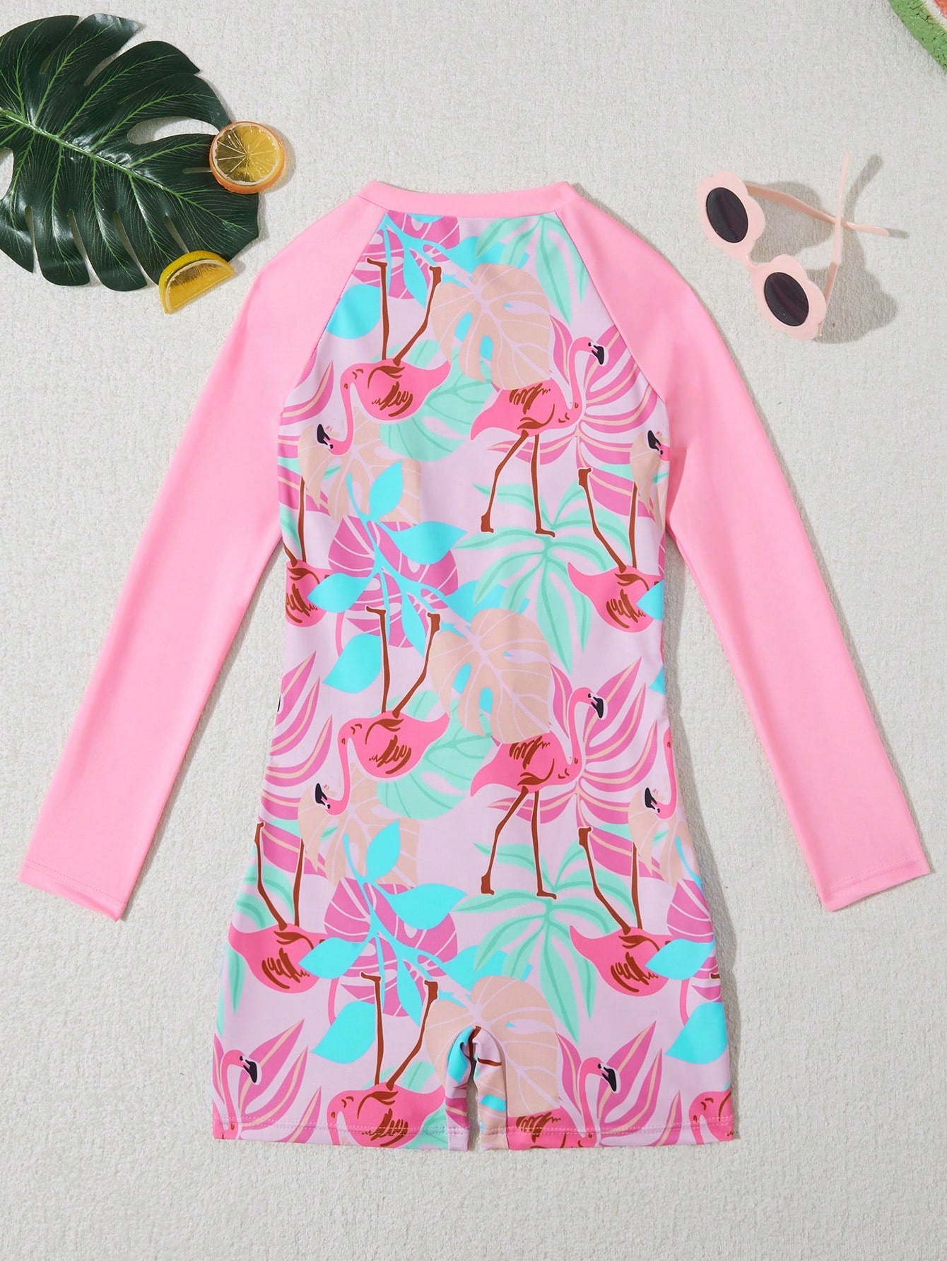 Tween girls one-piece swimsuit featuring a high neck, long sleeves, and shorts bottom, with a back zipper and strawberry plaid digital print on stretch knit fabric. Designed for swimming, vacation, and summer wear.