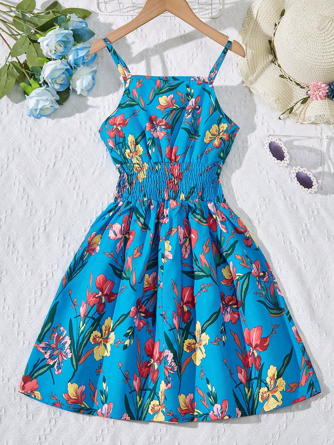 Tween girls floral mini dress with spaghetti straps, ruched shirred bodice, frill details, ruffle hem, high waist, and flared short silhouette for summer casual wear.