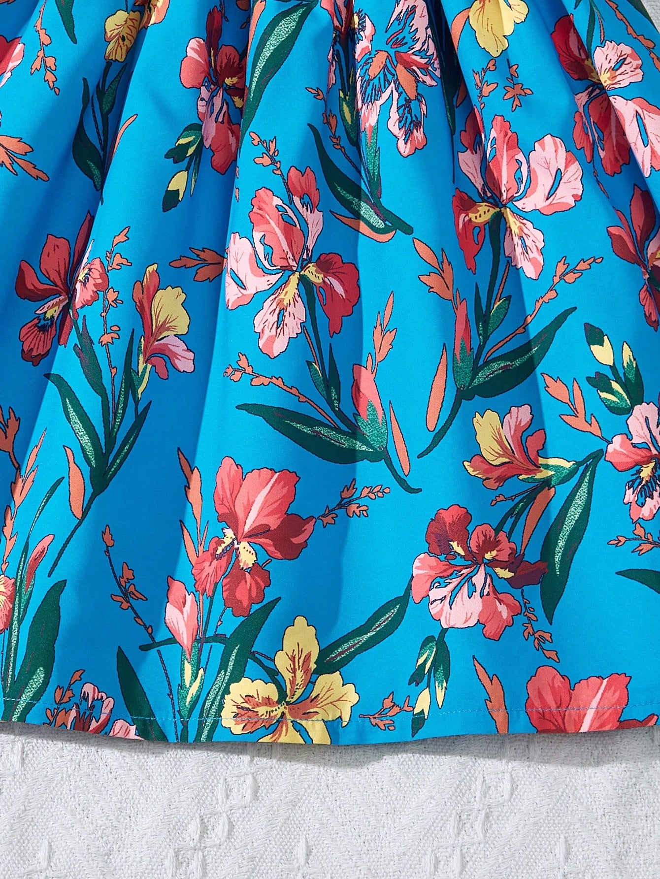Tween girls floral mini dress with spaghetti straps, ruched shirred bodice, frill details, ruffle hem, high waist, and flared short silhouette for summer casual wear.