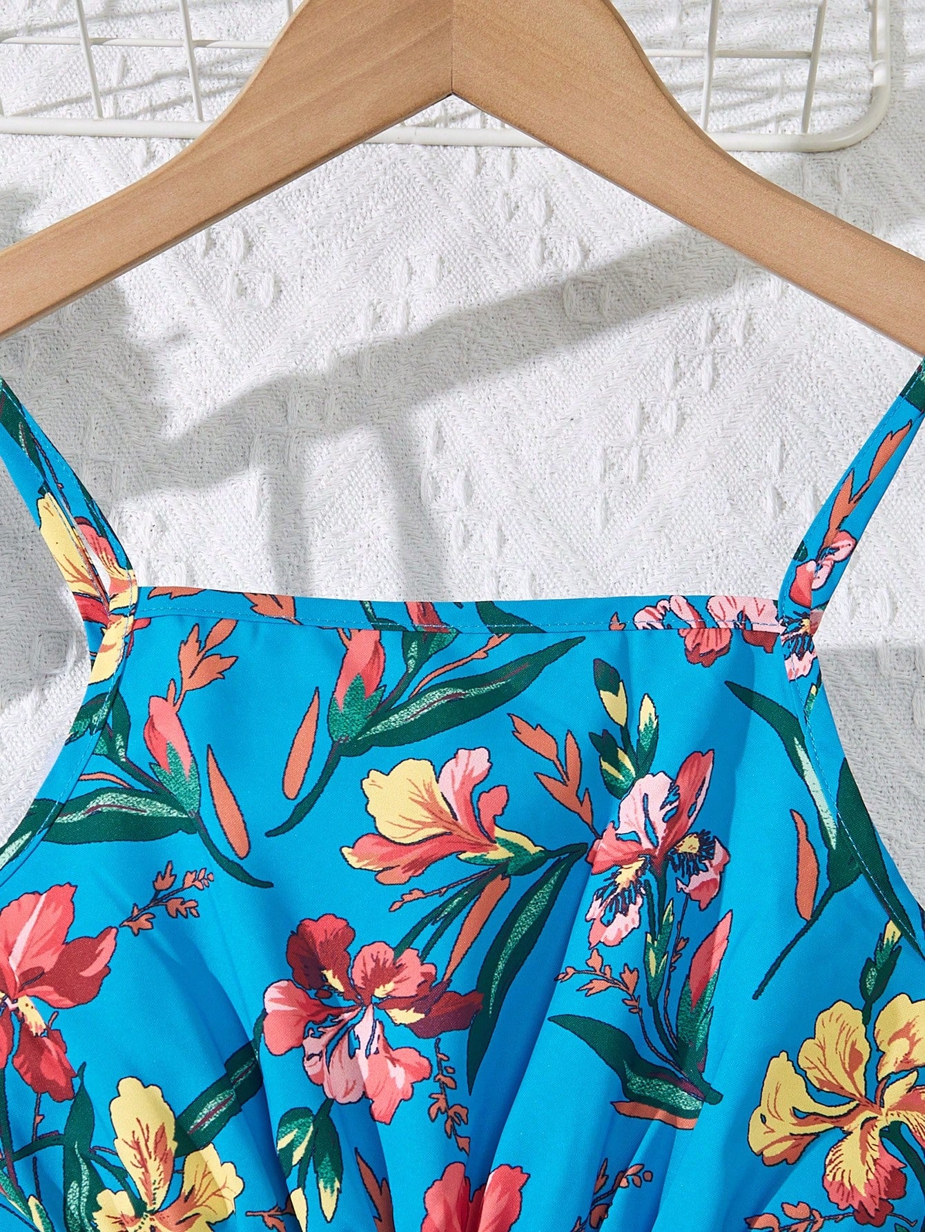 Tween girls floral mini dress with spaghetti straps, ruched shirred bodice, frill details, ruffle hem, high waist, and flared short silhouette for summer casual wear.