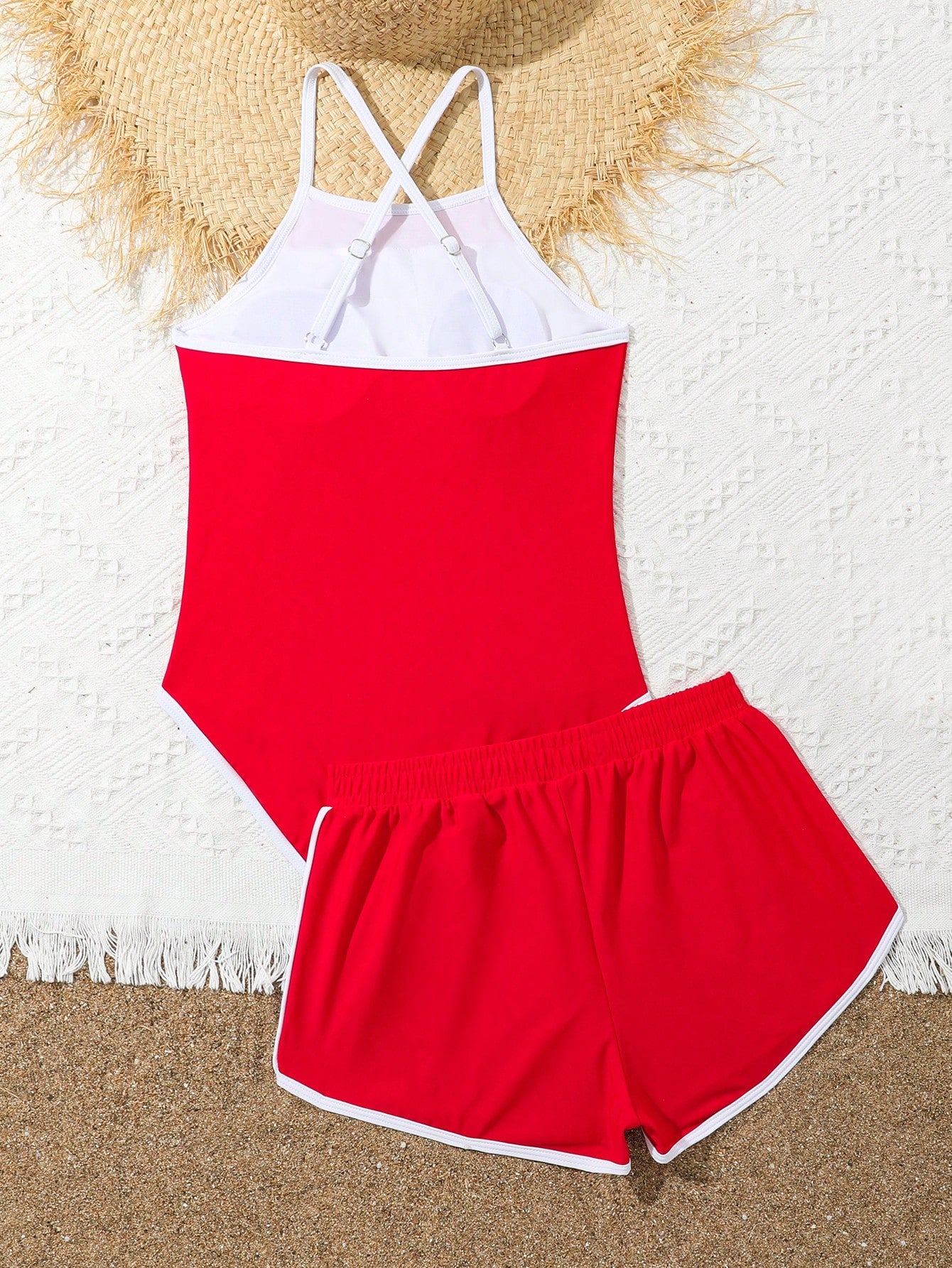 Girls' mauve purple one-piece swimsuit with swim shorts, spaghetti straps, contrast piping, letter pattern, and sleeveless vacation swimwear design.