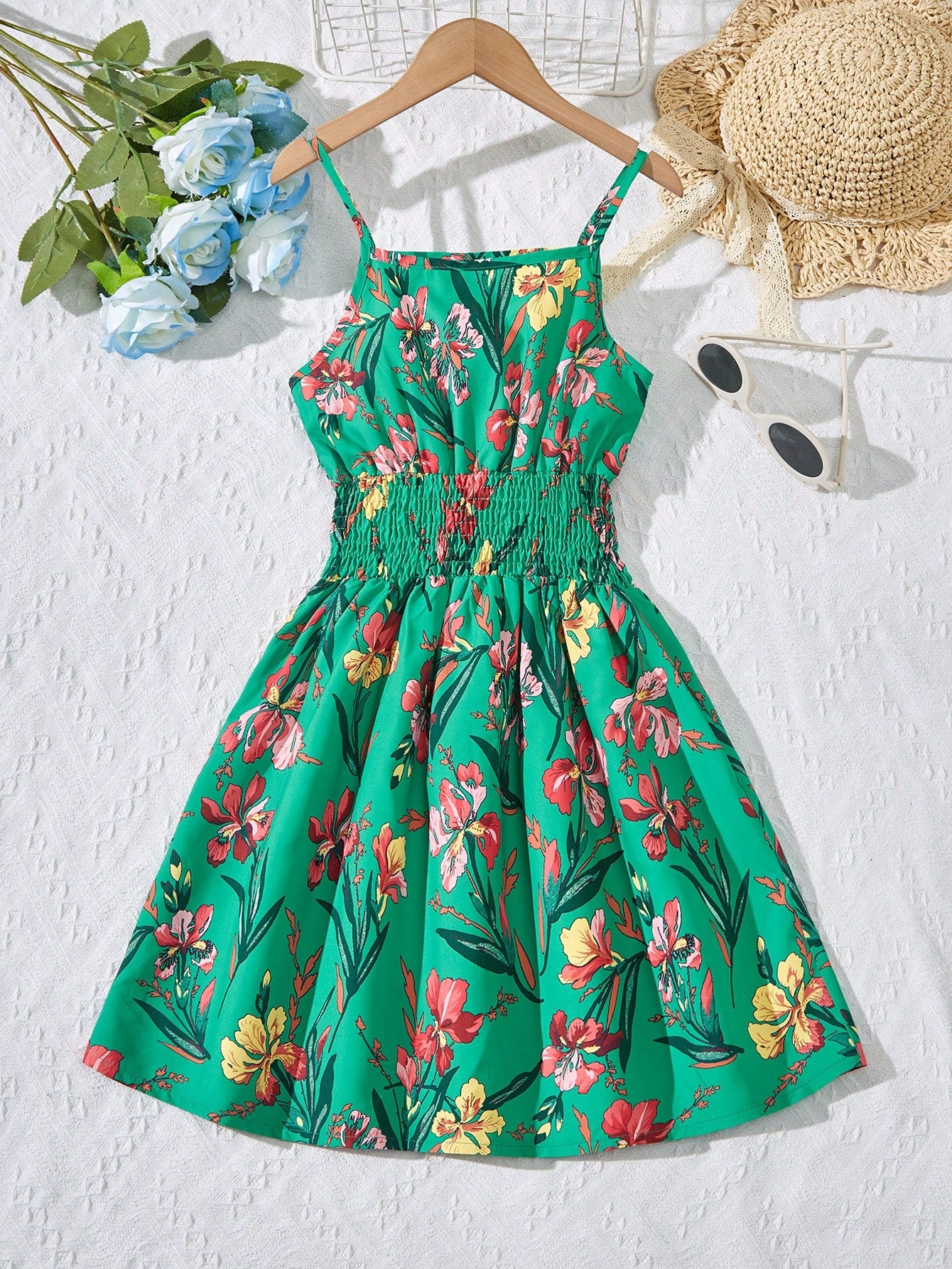 Tween girls floral mini dress with spaghetti straps, ruched shirred bodice, frill details, ruffle hem, high waist, and flared short silhouette for summer casual wear.