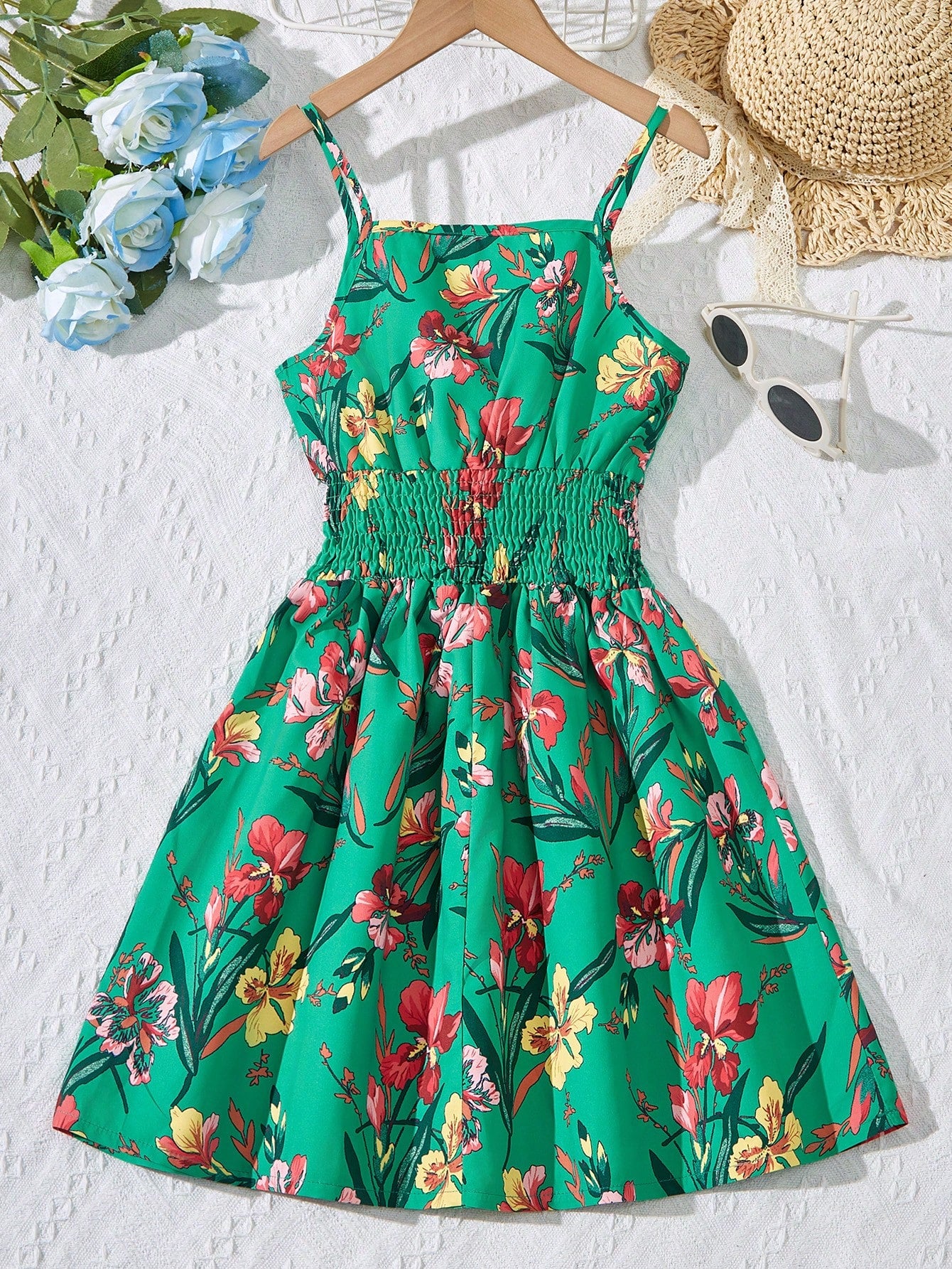 Tween girls floral mini dress with spaghetti straps, ruched shirred bodice, frill details, ruffle hem, high waist, and flared short silhouette for summer casual wear.