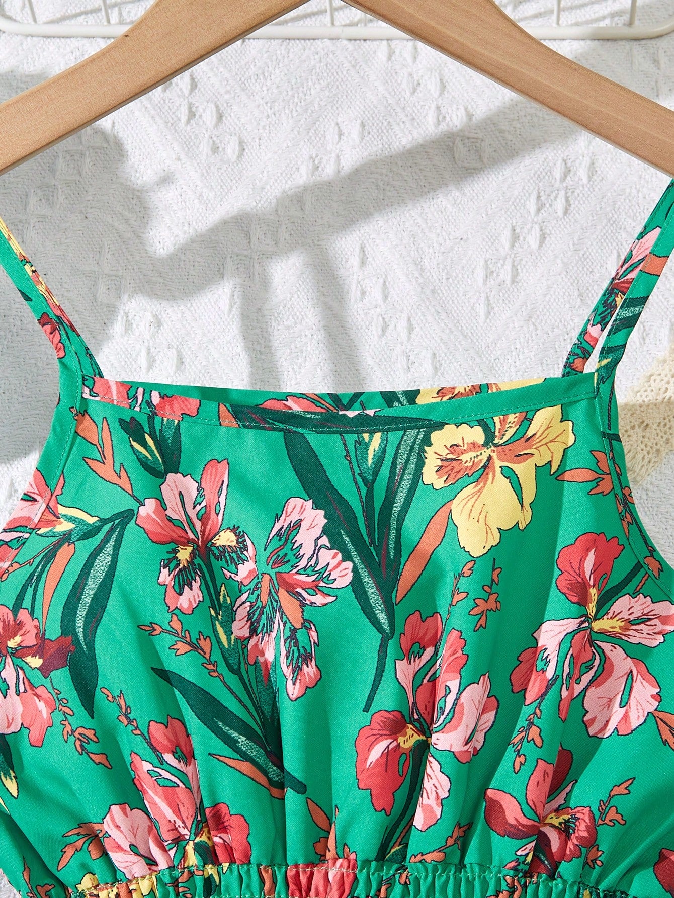Tween girls floral mini dress with spaghetti straps, ruched shirred bodice, frill details, ruffle hem, high waist, and flared short silhouette for summer casual wear.