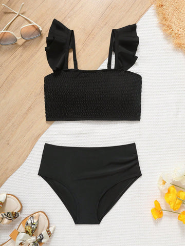 Tween girls tankini swimwear set with a solid color cap sleeve top featuring strap neckline and ruffle detail, paired with triangle-style briefs in a high-waist to mid-waist fit; two-piece vacation swim set.