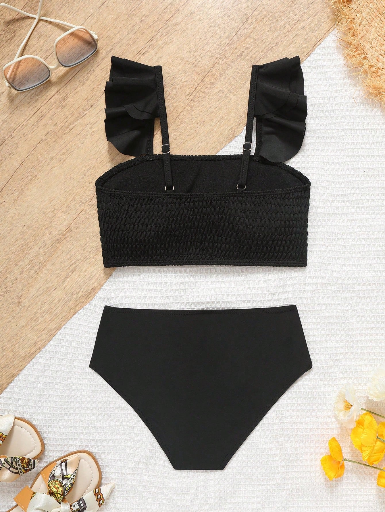 Tween girls tankini swimwear set with a solid color cap sleeve top featuring strap neckline and ruffle detail, paired with triangle-style briefs in a high-waist to mid-waist fit; two-piece vacation swim set.