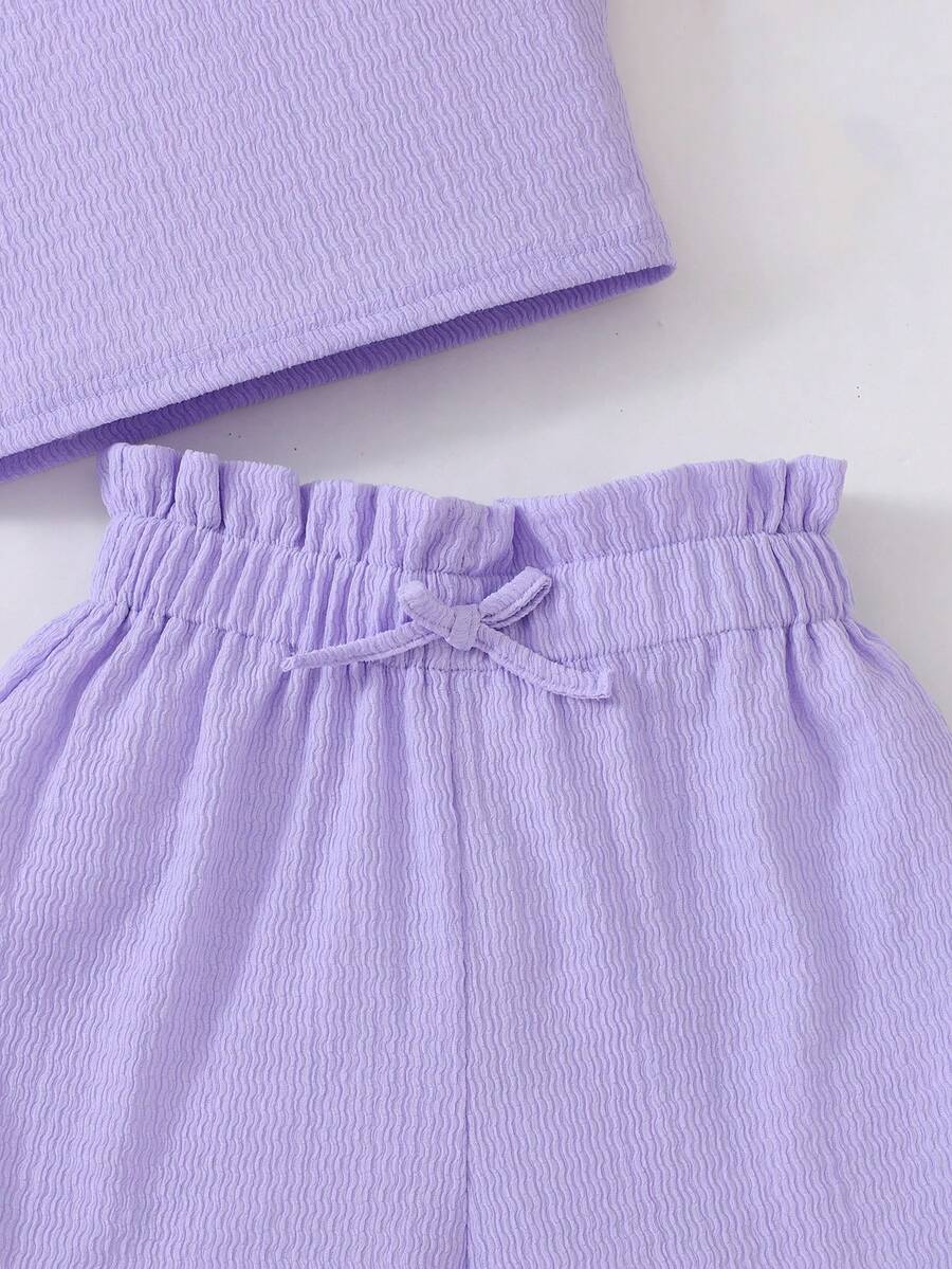 Tween girl 2-piece casual outfit set featuring a solid beige knit halter sleeveless top with belted detail and matching shorts.