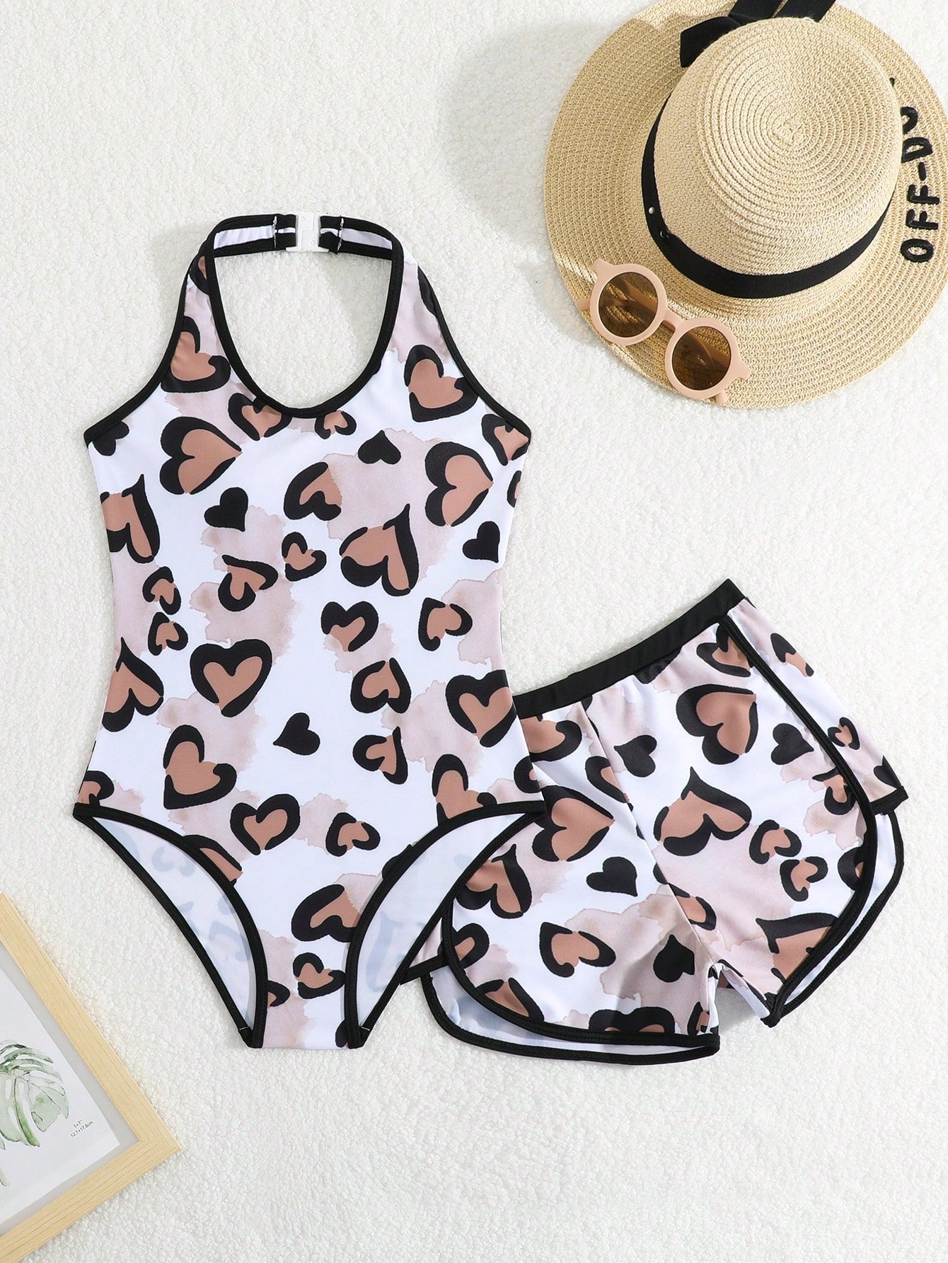 Girls 2-piece swimwear set featuring a butterfly print halter swimsuit top with contrast piping and separate mid-waist shorts; sleeveless, high-stretch, wireless design for beach and vacation wear.
