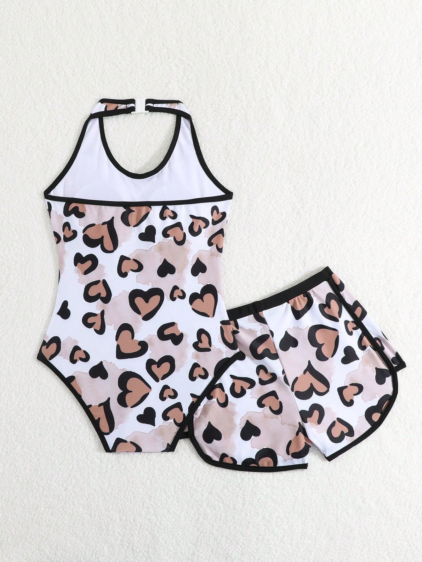 Girls 2-piece swimwear set featuring a butterfly print halter swimsuit top with contrast piping and separate mid-waist shorts; sleeveless, high-stretch, wireless design for beach and vacation wear.